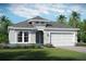 One-story home with gray exterior, white trim, and two-car garage at 2200 Seagrass Pt # 428, Kissimmee, FL 34747