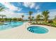 Relaxing pool and spa with surrounding palm trees at 2200 Seagrass Pt # 428, Kissimmee, FL 34747