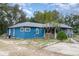 Blue house with a covered porch and fenced yard at 23627 Franklin Ave, Sorrento, FL 32776