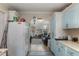 Bright kitchen with white cabinets and views of the living room at 23627 Franklin Ave, Sorrento, FL 32776