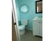 Clean bathroom with light blue walls, white vanity, and toilet at 2575 Edmond Cir, Auburndale, FL 33823