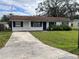 Ranch-style home with a carport and a spacious yard at 2575 Edmond Cir, Auburndale, FL 33823