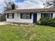 House exterior with blue front door and small yard at 2575 Edmond Cir, Auburndale, FL 33823