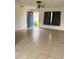 Living room with tile floor and blue door at 2575 Edmond Cir, Auburndale, FL 33823