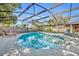 Enclosed kidney-shaped pool with lounge chairs and a view of the home at 3306 Florene Dr, Orlando, FL 32806