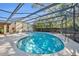 Enclosed kidney-shaped pool with plenty of lounge chairs for relaxation at 3306 Florene Dr, Orlando, FL 32806