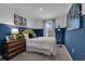 Cozy bedroom featuring a yellow headboard and blue walls at 3326 Thicket St, Tavares, FL 32778