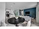 Open concept dining area with a black table and white chairs, near kitchen at 3326 Thicket St, Tavares, FL 32778