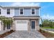 Charming two-story townhome featuring a private garage and stylish gray-toned brick driveway at 3326 Thicket St, Tavares, FL 32778