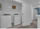 Laundry room with washer, dryer, and shelving at 3326 Thicket St, Tavares, FL 32778