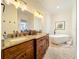 Elegant bathroom with double vanity, soaking tub, and tile flooring at 3415 S Mellonville Ave, Sanford, FL 32773