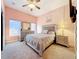 Comfortable bedroom with a queen-size bed, dresser, and soft carpeting at 3415 S Mellonville Ave, Sanford, FL 32773