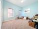 Light and airy bedroom with two windows and neutral-toned carpet at 3415 S Mellonville Ave, Sanford, FL 32773