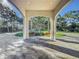 Covered patio with a seating area, offering views of the landscaped grounds at 3415 S Mellonville Ave, Sanford, FL 32773