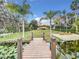 Wooden walkway leads to lakefront property with beautiful landscaping at 3415 S Mellonville Ave, Sanford, FL 32773