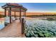 Wooden dock with gazebo and lake access; string lights add ambiance at 3415 S Mellonville Ave, Sanford, FL 32773