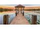 Wooden dock leading to a gazebo over serene lake waters at 3415 S Mellonville Ave, Sanford, FL 32773