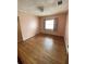 Light pink bedroom with hardwood floors and window at 3430 N Westmoreland Dr, Orlando, FL 32804