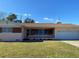 Ranch-style home with brick facade, attached garage, and well-maintained lawn at 3430 N Westmoreland Dr, Orlando, FL 32804