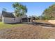 Spacious backyard with a screened patio and wooden fence at 417 Main Trl, Ormond Beach, FL 32174