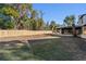 Spacious backyard with a new wooden fence and a screened-in porch, ideal for outdoor entertaining at 417 Main Trl, Ormond Beach, FL 32174