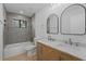 A modern bathroom with dual sinks, marble countertops, and sleek black mirrors, creating a spa-like retreat at 417 Main Trl, Ormond Beach, FL 32174