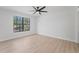 Bright bedroom featuring hardwood floors and a large window at 417 Main Trl, Ormond Beach, FL 32174