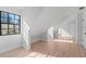 Bright bonus room with modern wood floors and a large window, perfect for an office or playroom at 417 Main Trl, Ormond Beach, FL 32174