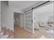 Entryway featuring a barn door that leads into the living room with modern furnishings at 417 Main Trl, Ormond Beach, FL 32174