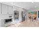 Modern kitchen with stainless steel appliances, light-colored cabinets, and a dining area near a window at 417 Main Trl, Ormond Beach, FL 32174