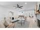 Open-concept living room with contemporary furnishings, including a modern fan and view to a kitchen bar at 417 Main Trl, Ormond Beach, FL 32174