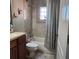 Clean bathroom with tub shower, tiled walls, and wood vanity at 510 N Leavitt Ave, Orange City, FL 32763