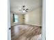 Large bedroom with wood-look floors and window at 510 N Leavitt Ave, Orange City, FL 32763