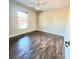 Spacious bedroom featuring wood-look floors and a large window at 510 N Leavitt Ave, Orange City, FL 32763