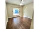 Bright bedroom with wood-look floors and ceiling fan at 510 N Leavitt Ave, Orange City, FL 32763