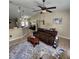 Living room features a comfy couch and a ceiling fan at 510 N Leavitt Ave, Orange City, FL 32763