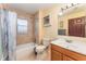 Clean bathroom with a shower/tub combo and wood vanity at 5572 Myakka Ave, Intercession City, FL 33848