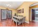 Dining room with wood floors and gray table at 5572 Myakka Ave, Intercession City, FL 33848