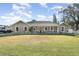 Tan house with white trim, front porch, and grassy lawn at 5572 Myakka Ave, Intercession City, FL 33848