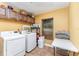 Laundry room with washer, dryer, and overhead cabinets at 5572 Myakka Ave, Intercession City, FL 33848