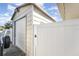 White metal storage shed with roll-up door at 5572 Myakka Ave, Intercession City, FL 33848