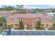 Exterior aerial showcases a modern townhome community with terracotta roofs and manicured landscaping at 5767 T Bird Ln, Kissimmee, FL 34746