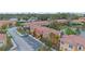 Exterior aerial showcases a townhome community featuring terracotta roofs, lush landscaping, and scenic ponds at 5767 T Bird Ln, Kissimmee, FL 34746