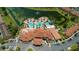 Aerial view showcasing a luxurious pool, clubhouse, and waterslides nestled by a lake at 5767 T Bird Ln, Kissimmee, FL 34746