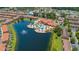 Stunning aerial view showcases resort-style pool, clubhouse, and surrounding residential community by a scenic lake at 5767 T Bird Ln, Kissimmee, FL 34746