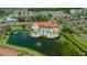 Aerial view featuring a luxurious pool, clubhouse, and surrounding residences near a lake at 5767 T Bird Ln, Kissimmee, FL 34746