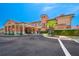 Exterior front of clubhouse with covered entrance, tile roof, and palm trees at 5767 T Bird Ln, Kissimmee, FL 34746