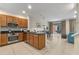 Modern kitchen with stainless appliances, island with sink, and adjacent dining area at 5767 T Bird Ln, Kissimmee, FL 34746