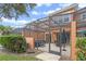 A screened patio with a hot tub, dining and lounge area, perfect for outdoor relaxation at 5767 T Bird Ln, Kissimmee, FL 34746