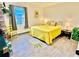 Bright bedroom with a yellow comforter and decor at 631 Callahan St, Winter Park, FL 32789